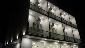 A multi-story building with balconies, air conditioning units, and multiple windows. - Heaven By O (Unawatuna)