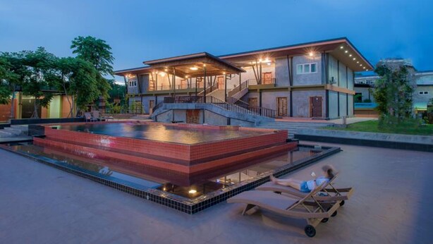 A modern house with a swimming pool and a covered outdoor area.