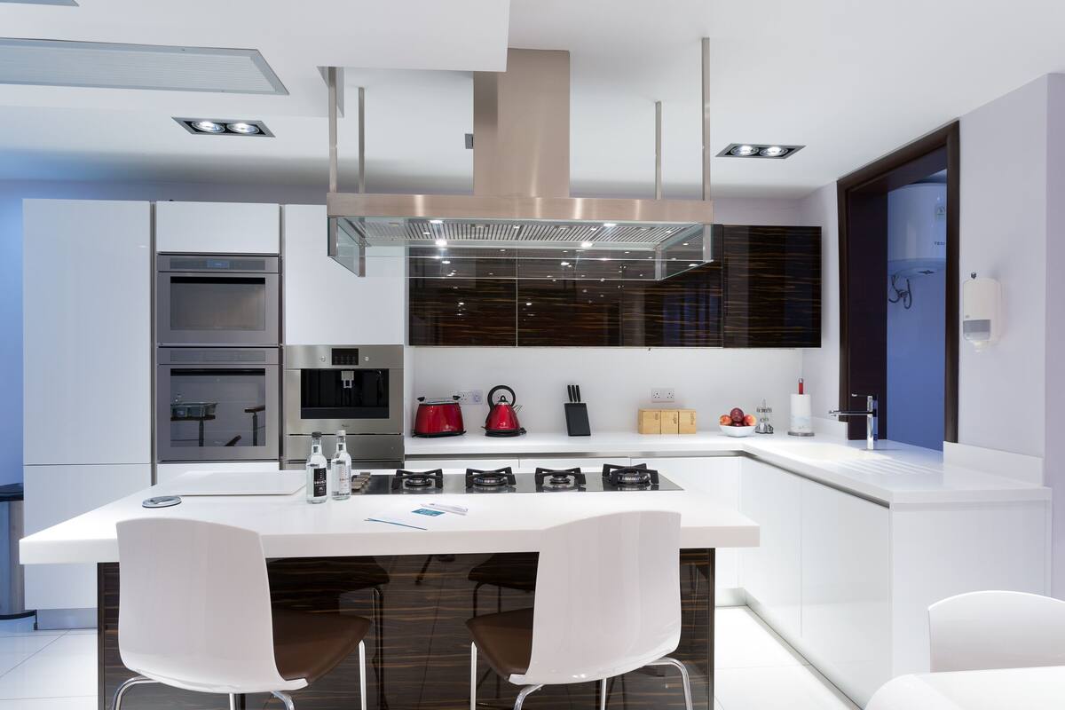 A modern kitchen with a central island, stainless steel appliances, and a sleek design.