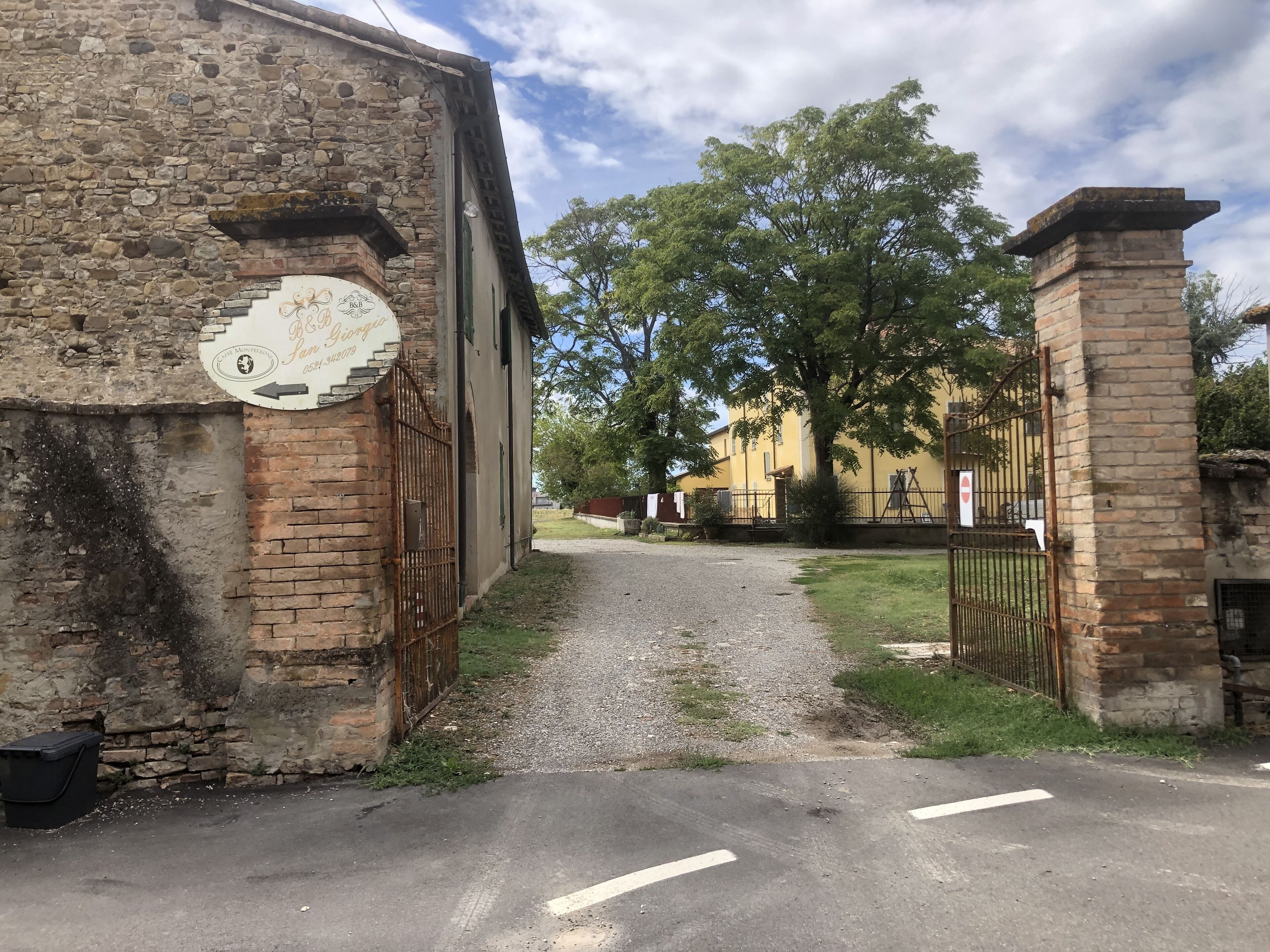 A rustic stone building with a sign indicating a restaurant named "Ristorante San Giorgio."