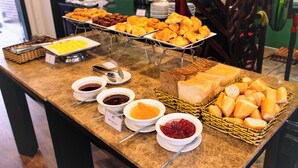 A buffet with various food items including pastries, bread, and condiments. - TTC Hotel – Hoi An (Da Nang)