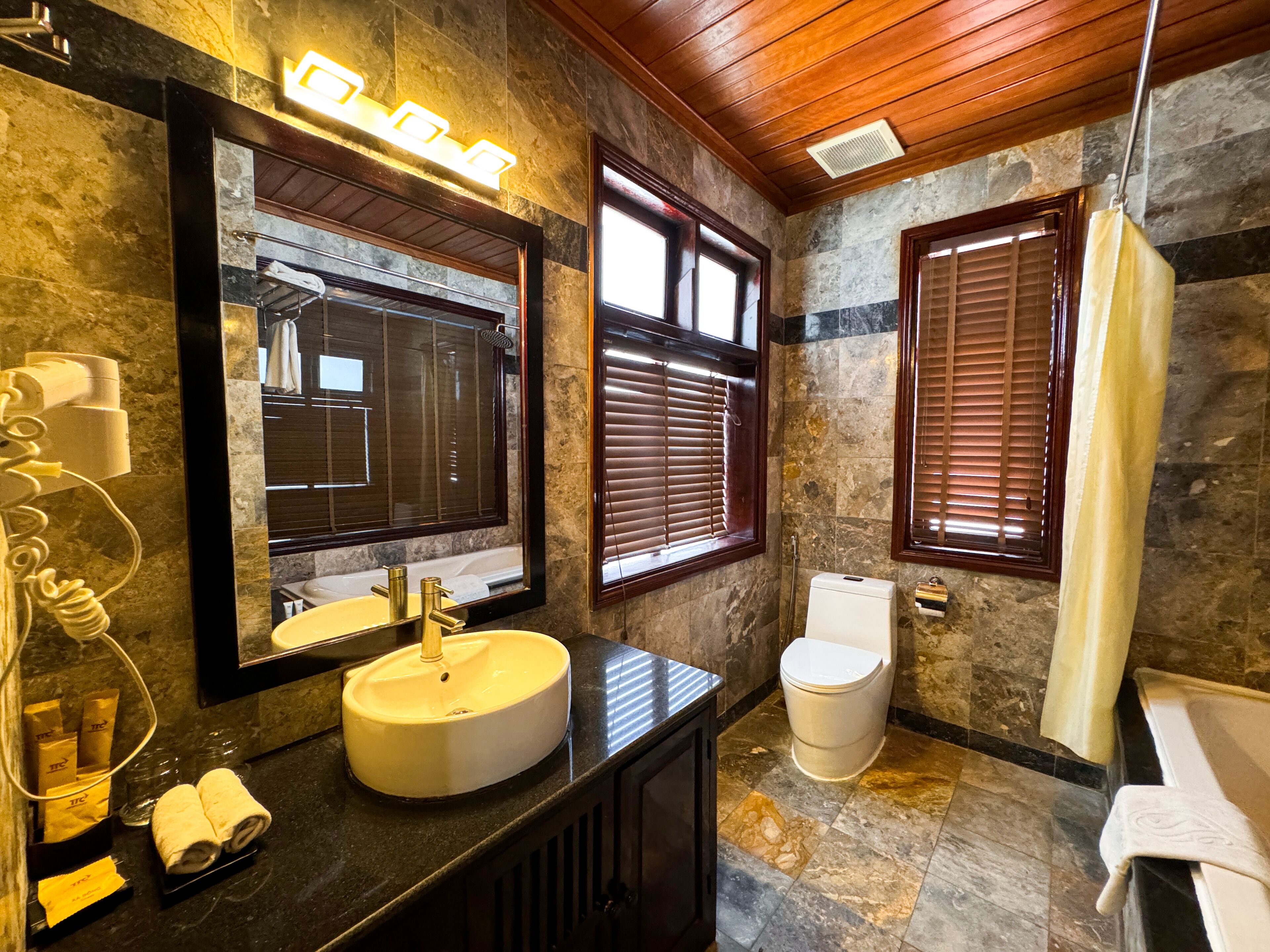 signature pool view | bathroom | free toiletries, hair dryer, bathrobes, slippers