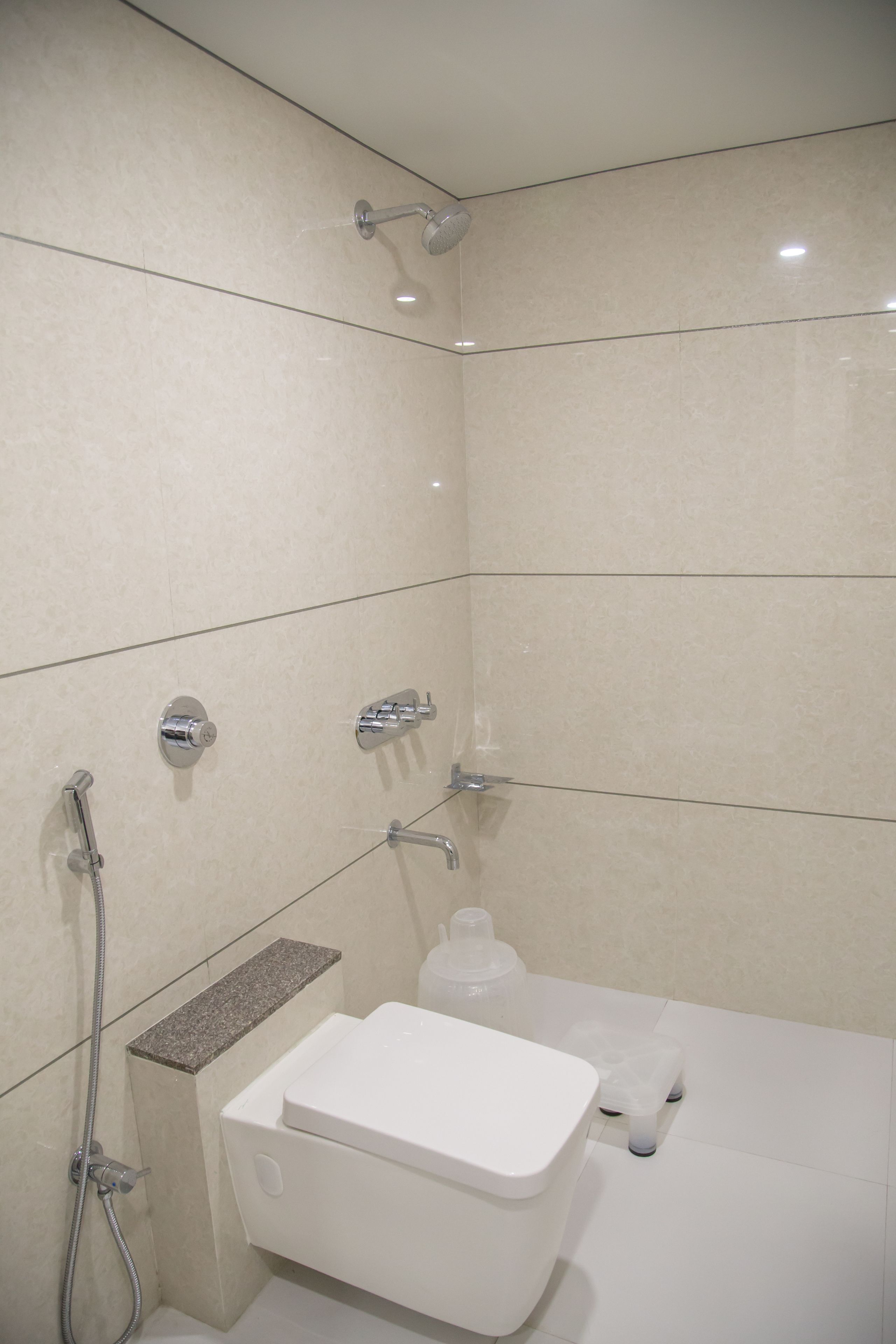 A bathroom with a toilet, a shower, and a sink.