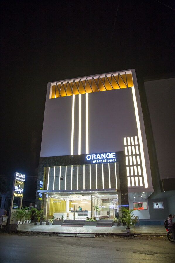 A modern building with the sign "Orange International" at the entrance.