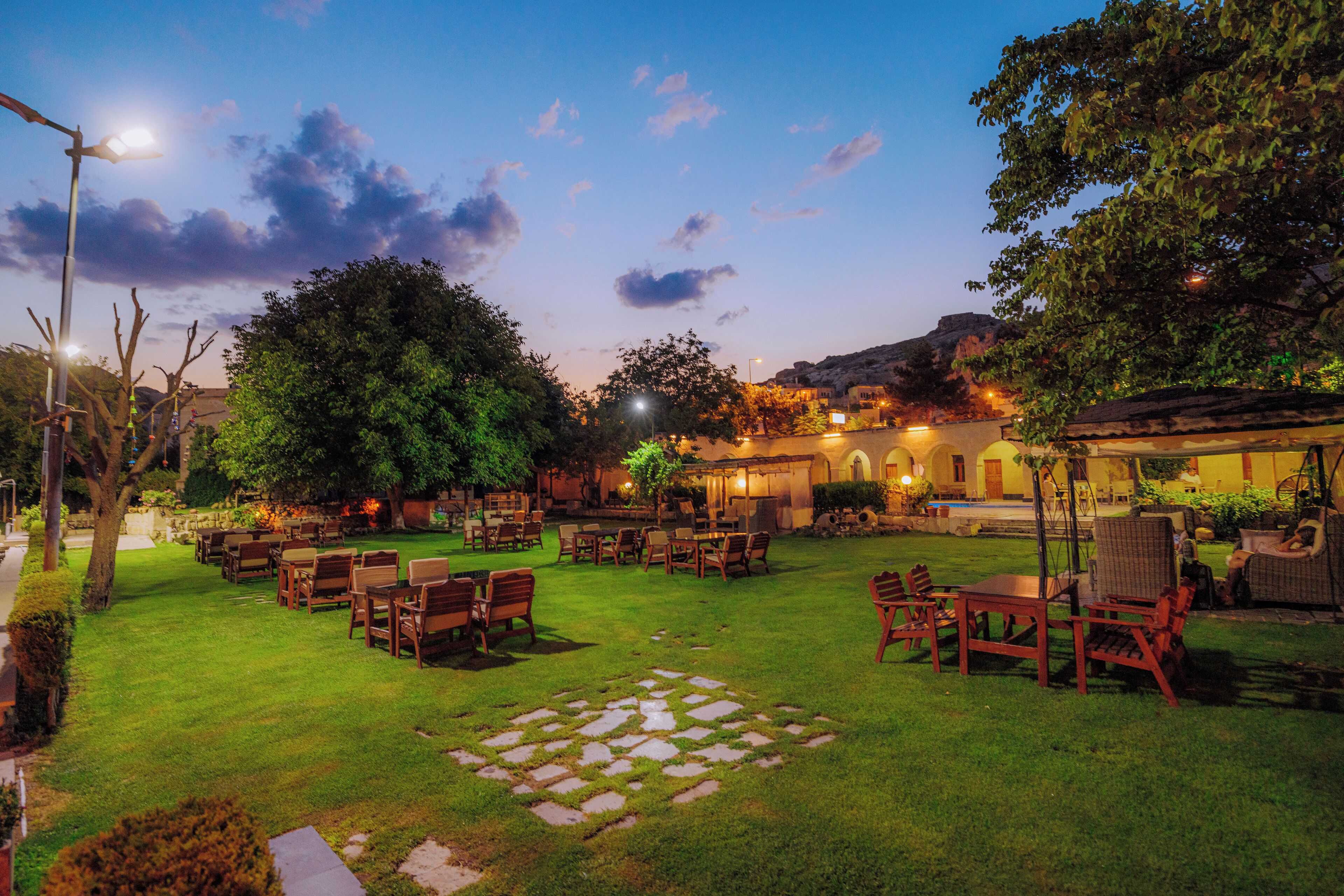 A well-maintained outdoor patio area with seating arrangements and a stone pathway.
