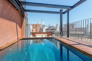 Outdoor pool, open 10:00 AM to 8:00 PM, pool umbrellas