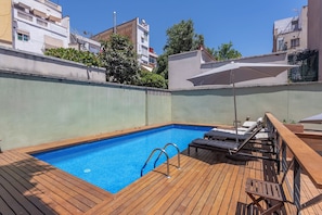 Outdoor pool, open 10:00 AM to 8:00 PM, pool umbrellas