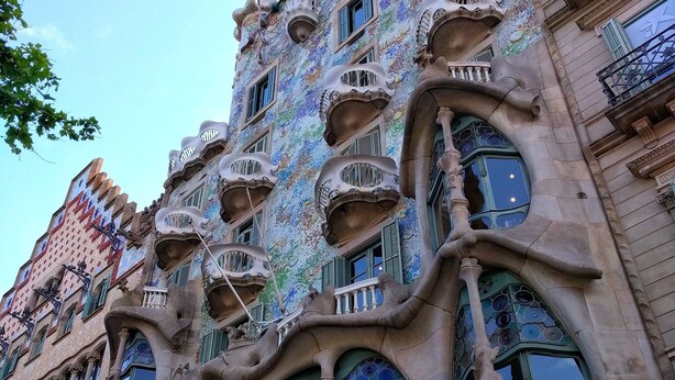 A building with unique architectural features, including organic shapes and decorative elements.