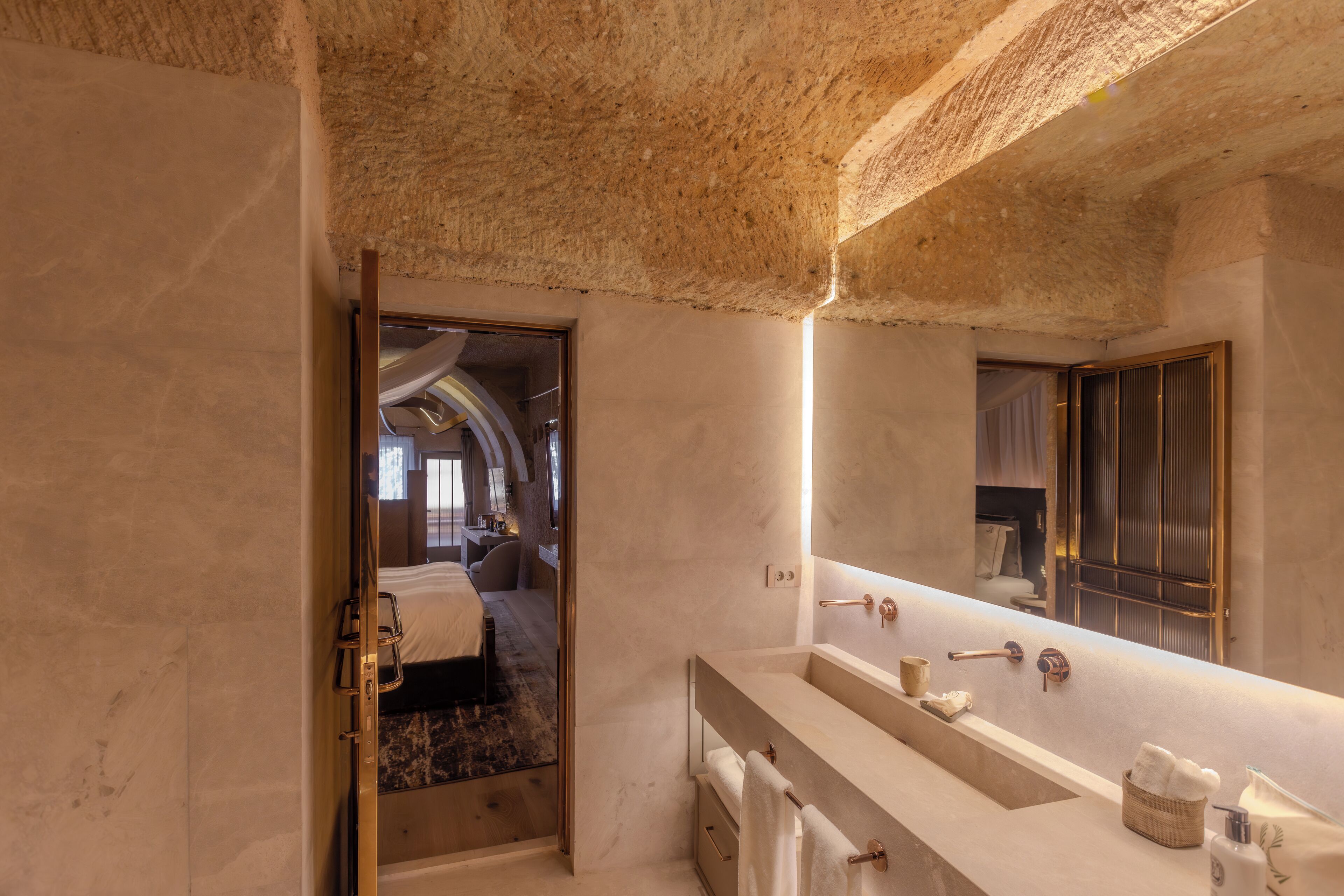 A modern bathroom with a large mirror, a bathtub, and a walk-in shower.
