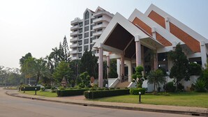 A modern hotel with a multi-story structure, a covered entrance, and well-maintained landscaping.