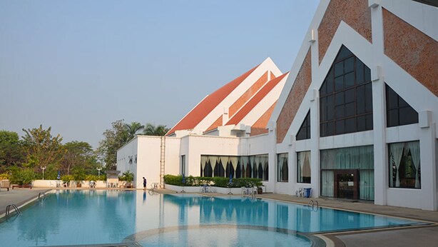 A swimming pool with a modern building in the background.