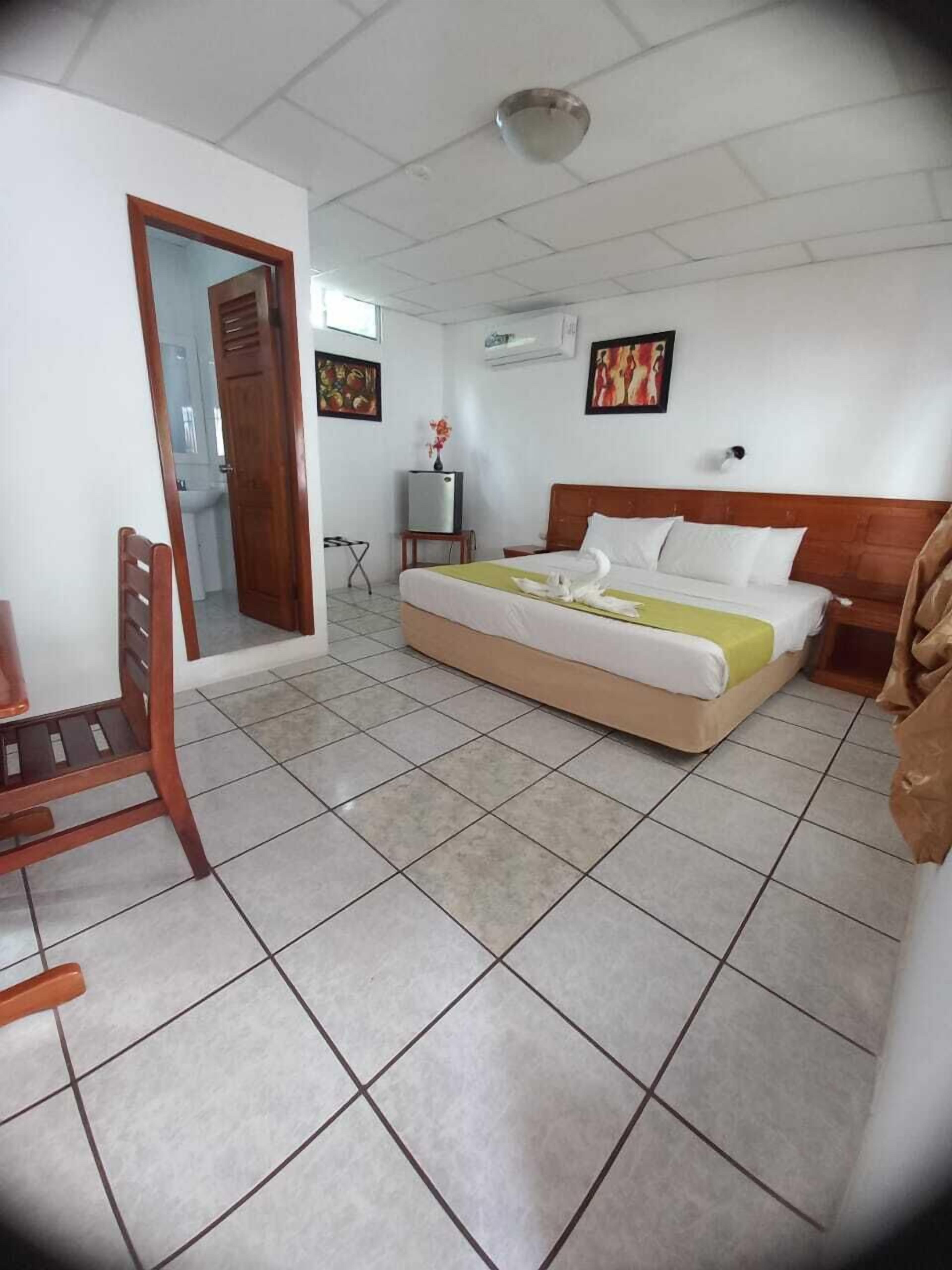 economy room, 1 queen bed, private bathroom | in-room safe, desk, iron/ironing board, free wifi
