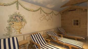 Una cabaña de madera con un mural de un carruaje y follaje, y cuatro sillones a rayas.