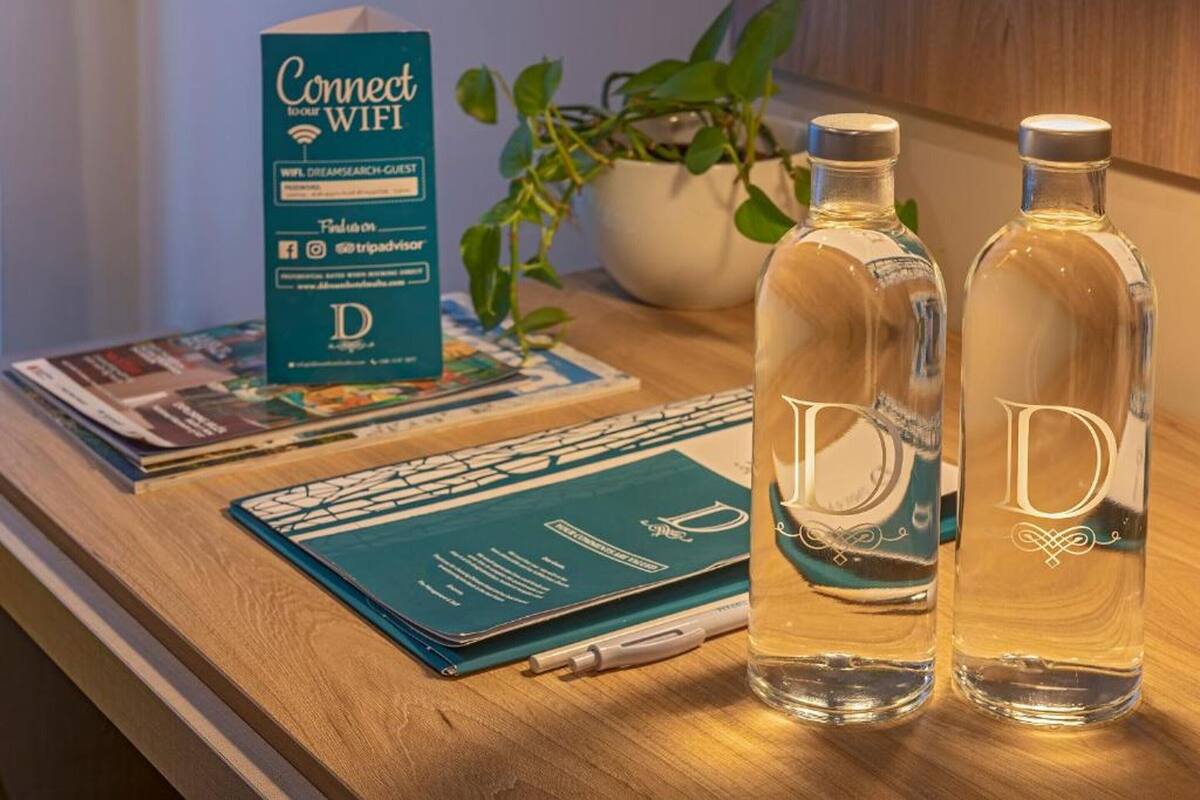 A table with a box labeled "Connect to WIFI," two bottles with the letter "D" on them, a notebook, and a pen.