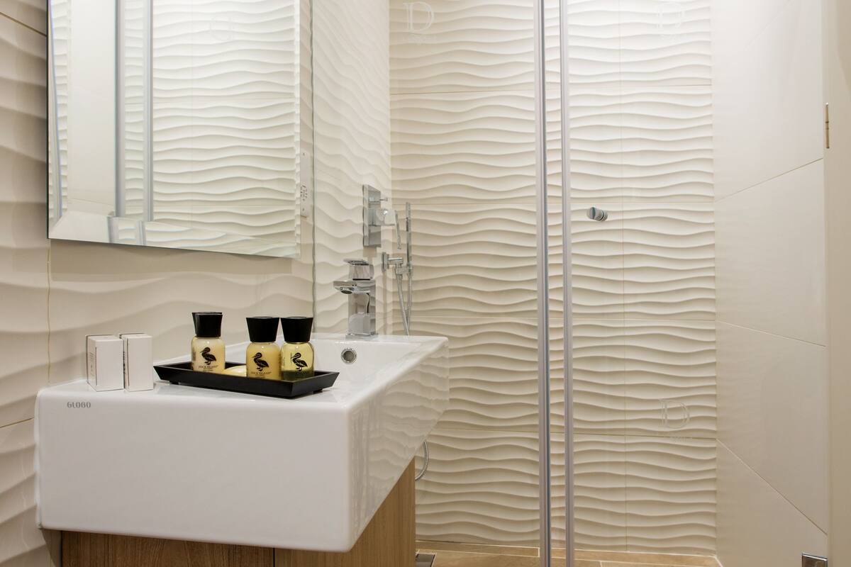 family room | bathroom | designer toiletries, hair dryer, bathrobes, slippers