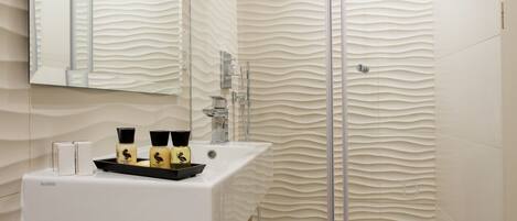 A modern bathroom with a wooden vanity, a glass shower enclosure, and a textured wall design.