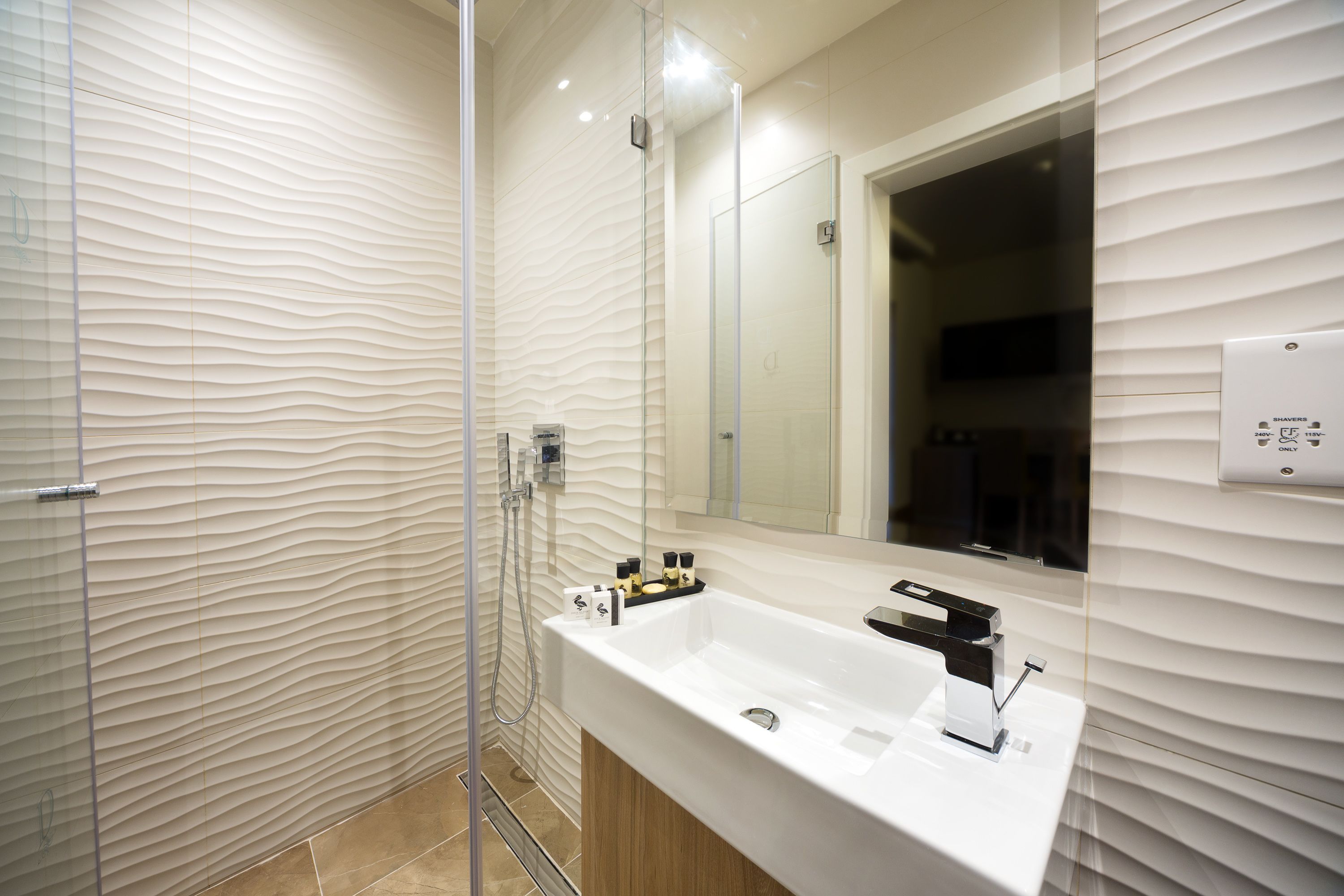 designer toiletries, hair dryer, bathrobes, slippers