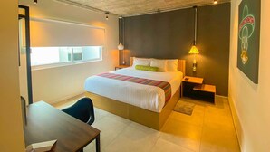 A hotel room with a bed, bedside table, chair, and a window. - Hotel VIVE MX wtc CDMX, Trademark Collection by Wyndham (Mexico City)