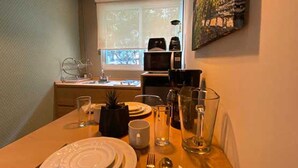 A dining area with a table set for two, including plates, cutlery, and glasses. - Hotel VIVE MX wtc CDMX, Trademark Collection by Wyndham (Mexico City)