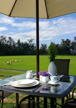Enjoy a serene meal or tea service in this outdoor space with a picturesque view.
