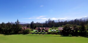 Escape to a serene golf resort surrounded by lush forest and majestic mountains.