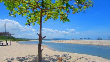 On the beach, surfing