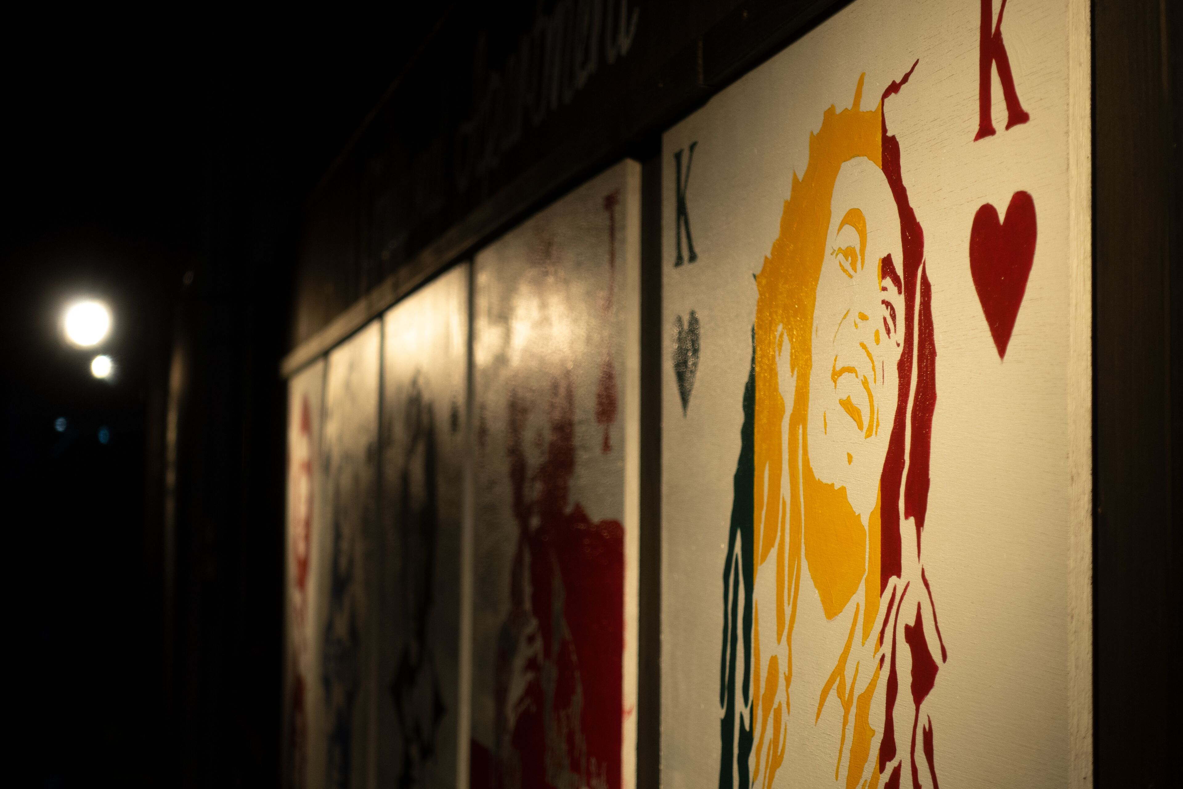A wall with graffiti art, including a prominent figure with a heart symbol.