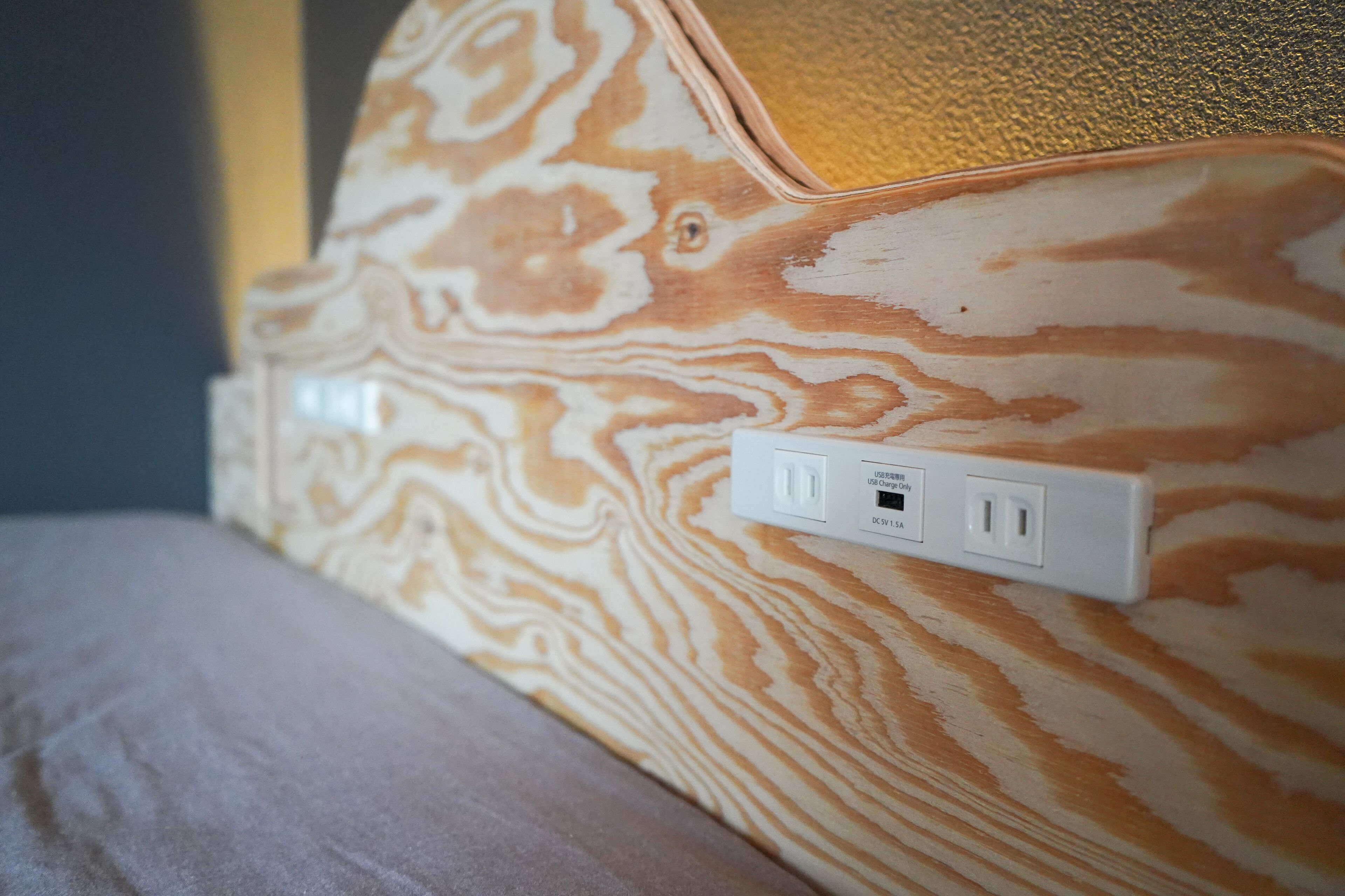 A wall with a power outlet and a USB port.