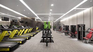 Ein Fitnessstudio mit Laufbändern, Krafttrainingsgeräten und Trainingsausrüstung.