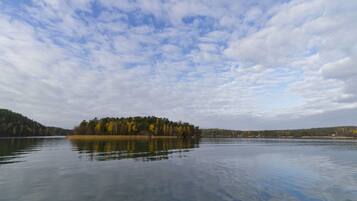 A calm lake with a forested island in the center.