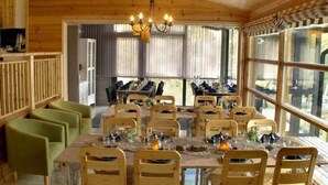 A wooden dining room with a large table set for six, surrounded by wooden chairs. - Äijälän Rusti Paratiisisaari (Naantali)