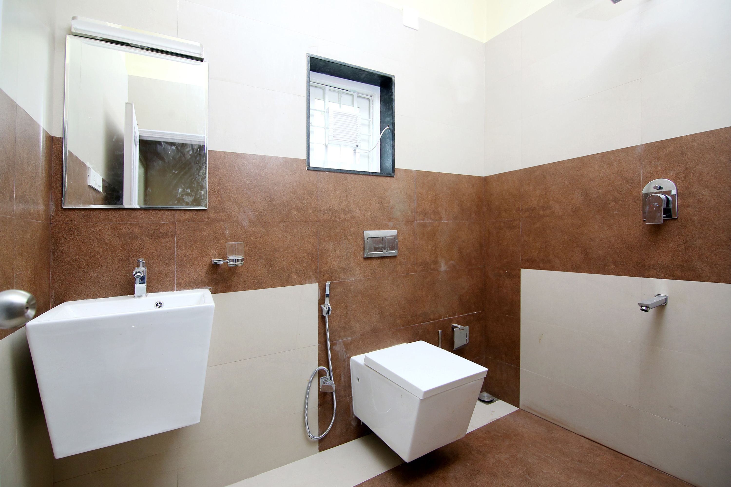Ein Badezimmer mit Waschbecken, Spiegel, Dusche und Toilette.