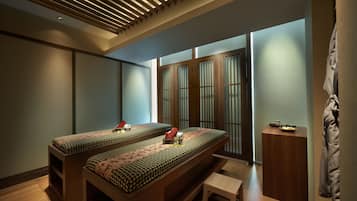 Traditional room with a low, elongated bed and a wooden ceiling with slats.