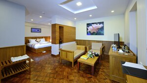 A hotel room with a bed, a sofa, a desk, and a TV. - Hotel H Valley Yangon (Yangon)