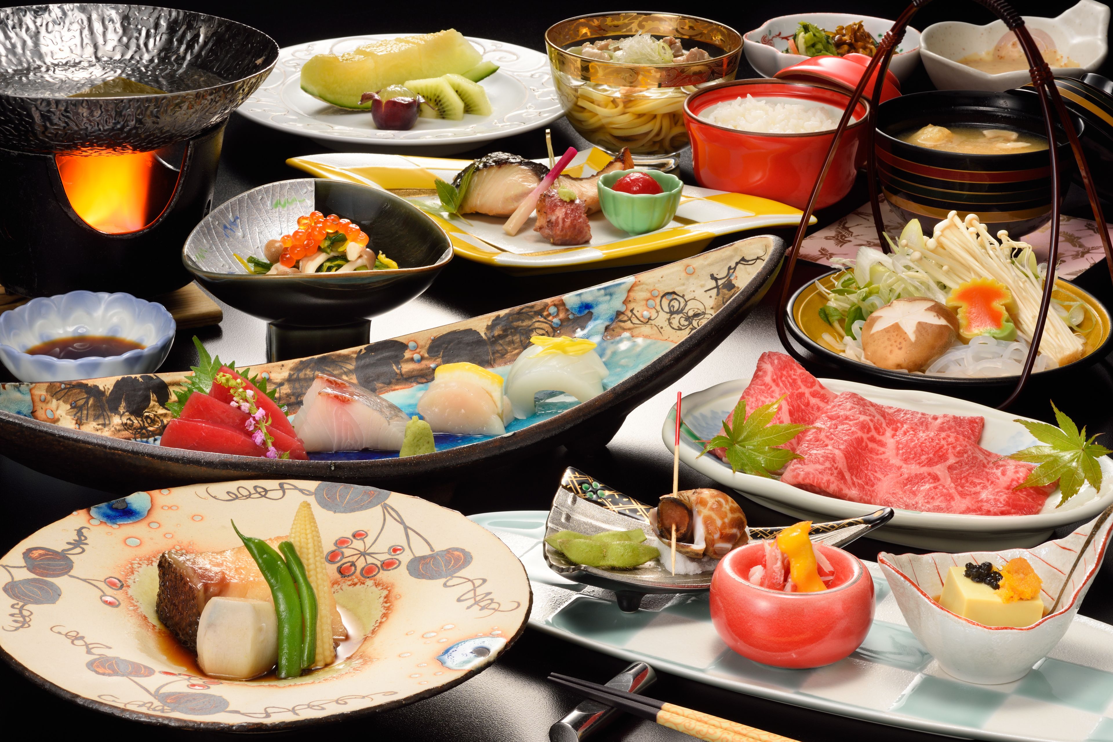 A variety of dishes and a hot pot setup, likely indicating a dining experience.