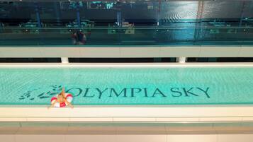A swimming pool with the words "OLYMPIA SKY" on the edge.