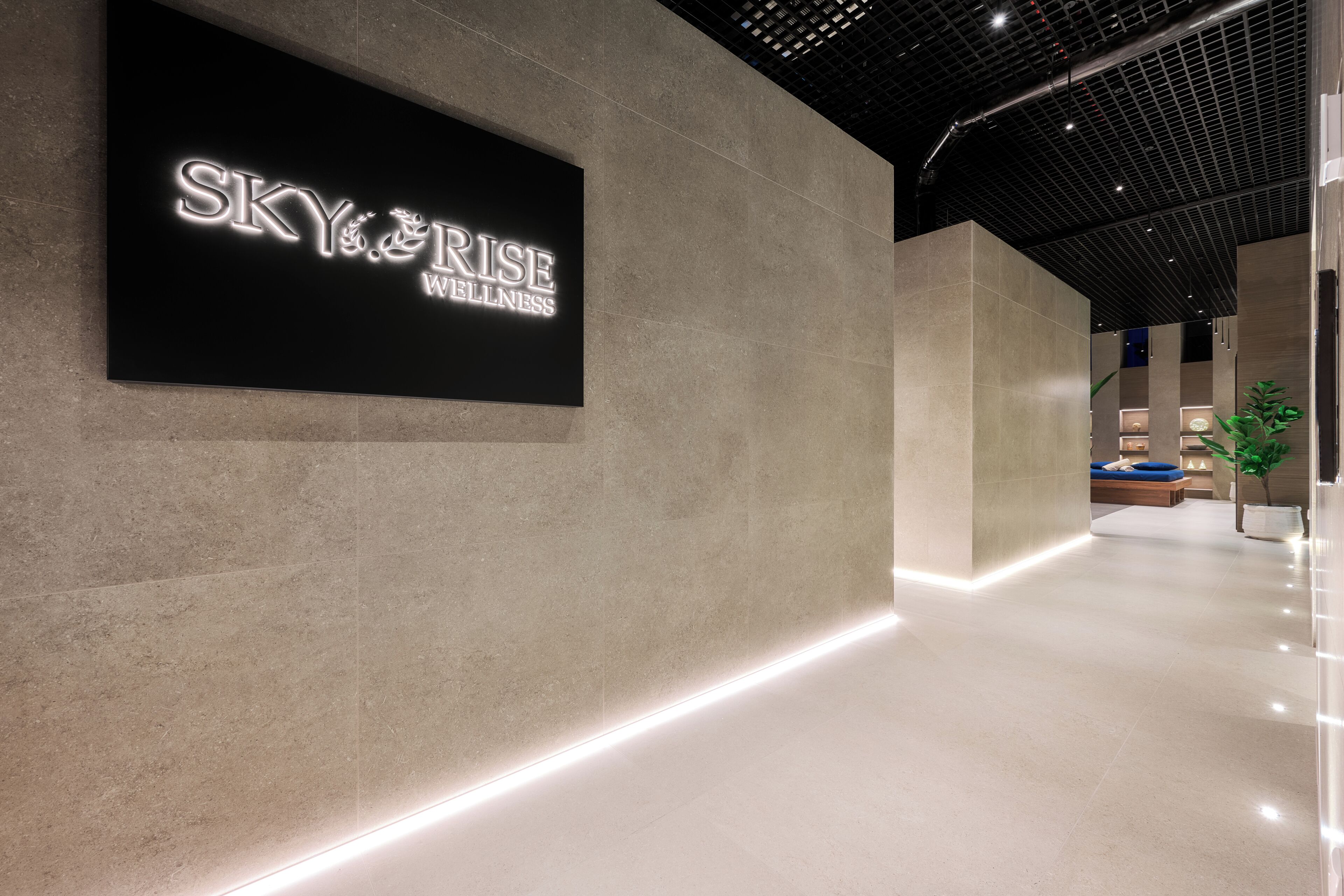 A modern interior with a sign reading "SKY RISE WELLNESS".