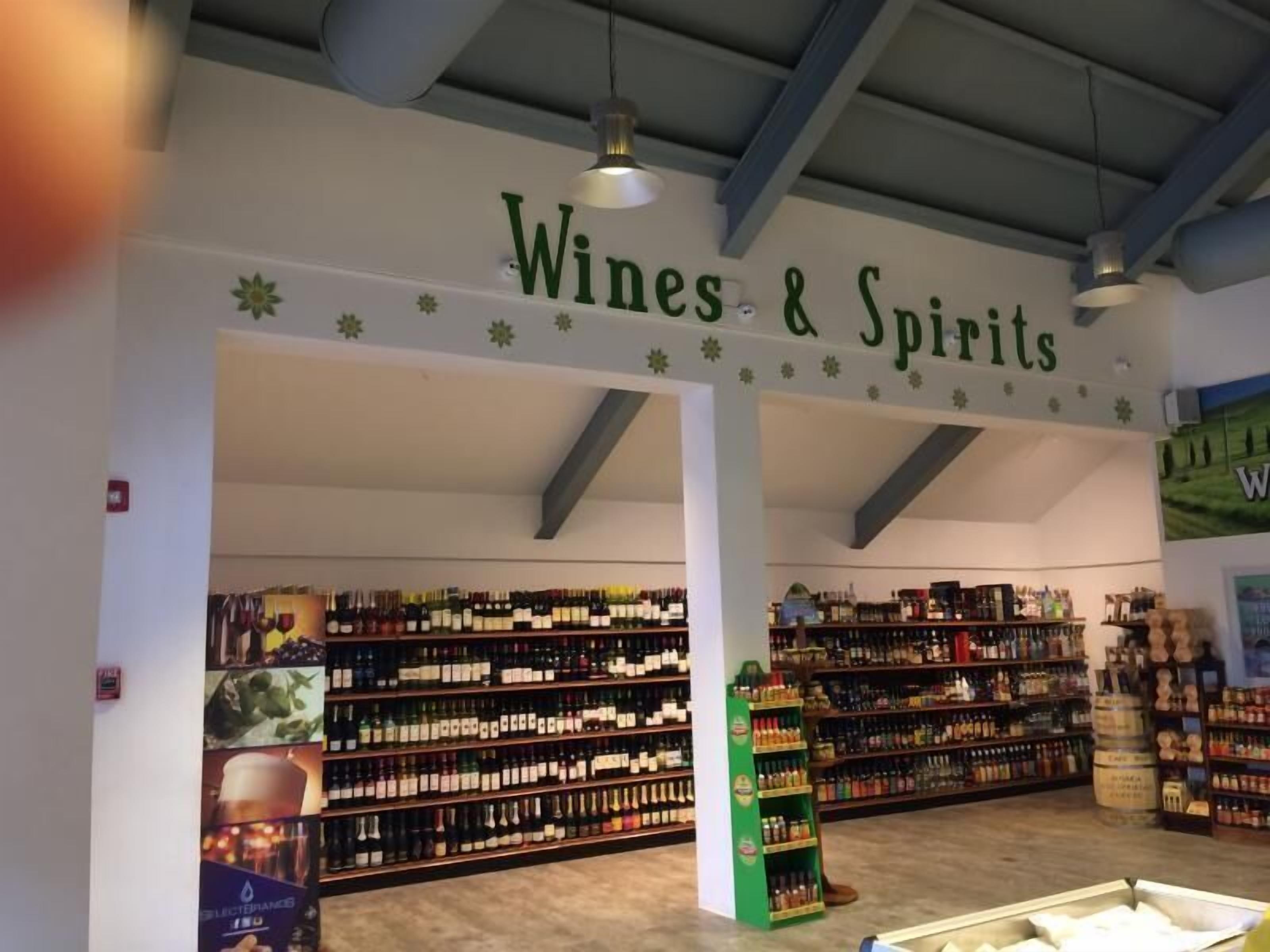 A store interior labeled "Wines & Spirits" with shelves stocked with various bottles.