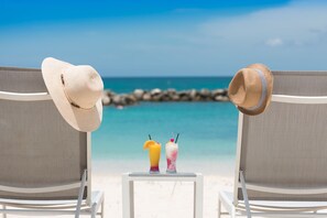 Private beach, white sand, sun-loungers, beach umbrellas - Margaritaville Beach Resort Grand Cayman (Seven Mile Beach)