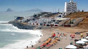 A coastal area with buildings, a beach, and the ocean. - QALA Hotel & Resorts (Grocio Prado)