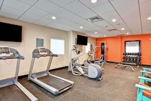Stay fit on the go with our fully equipped fitness center featuring treadmills, an elliptical machine, and a weight bench.