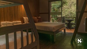 Ein Schlafzimmer mit Bett, Kissen und Blick ins Freie.