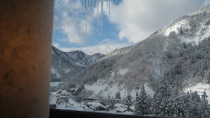 A snowy mountain landscape with icicles hanging from a ceiling. - Gokasanso (Nanto)