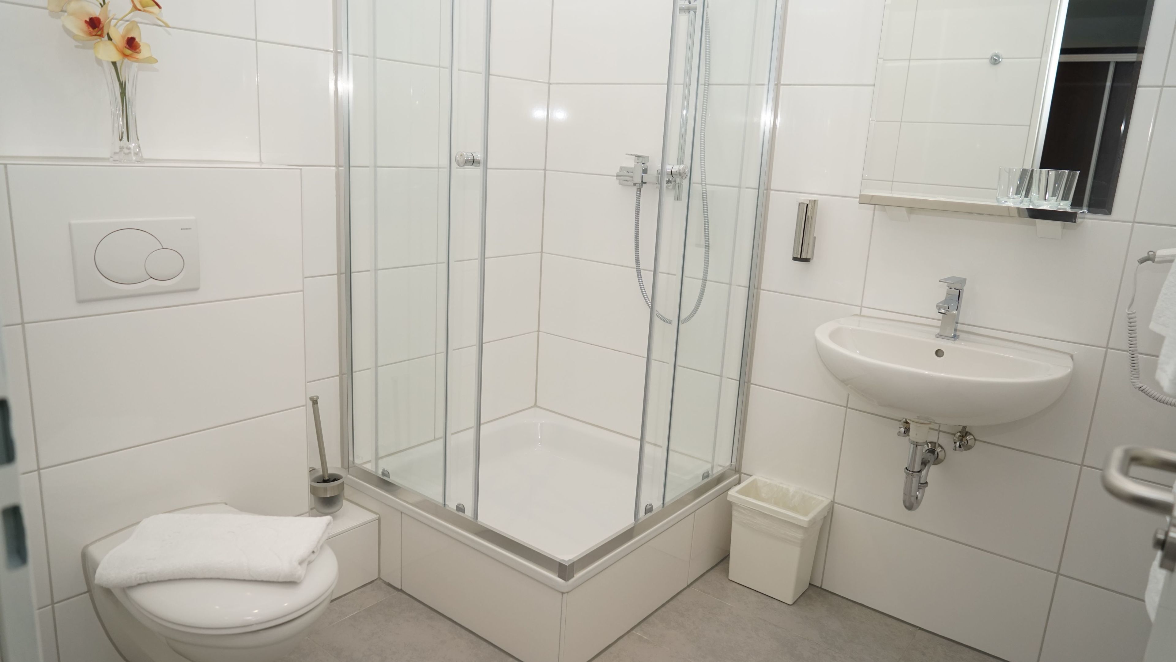 standard double room | bathroom | shower, hair dryer, slippers, towels