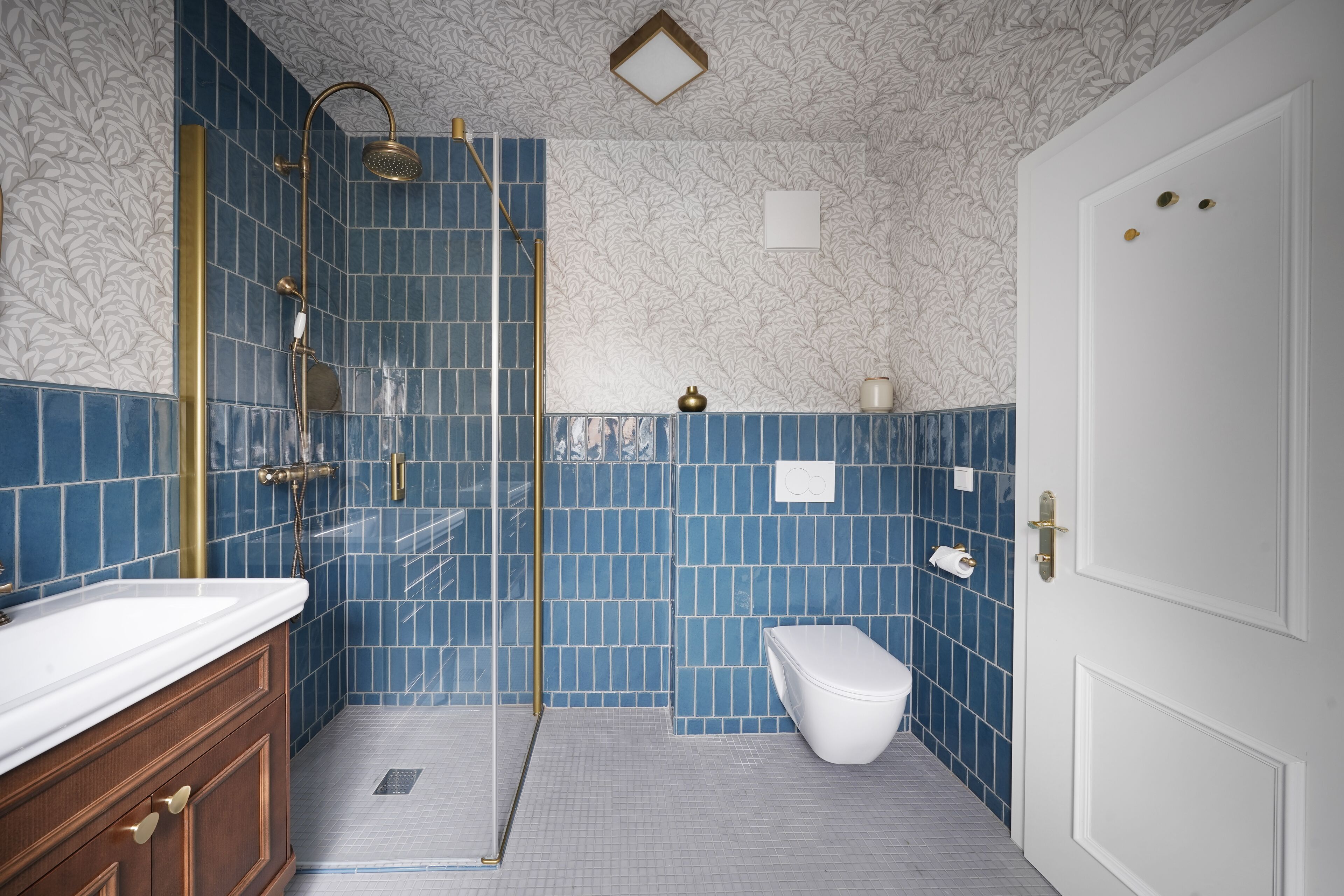 A bathroom with a shower, toilet, and sink.