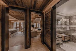 Family Suite with 2 Bedrooms and 1 Bathroom | Living area | 56-inch LCD TV with cable channels, TV, fireplace - Ultima Hotel Gstaad (Saanen)