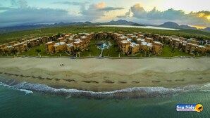 A resort with multiple buildings, a central pool, and a beach. - Las Glorias LG307 3 Bedroom Apartment By Seaside San Carlos (San Carlos)