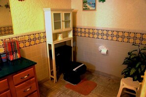 A bathroom with a toilet, cabinet, and sink. - Bahia 189 Bottom Chip s Place 1 Bedroom Apartment By Seaside San Carlos (San Carlos)