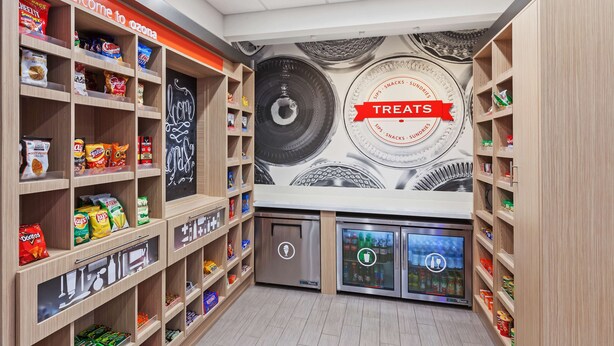 A snack area with shelves stocked with various snacks and a refrigerated section. - Hampton Inn Ozona (Ozona)