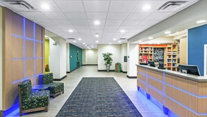 A hotel lobby with seating, a reception desk, and a plant. - Hampton Inn Ozona (Ozona)